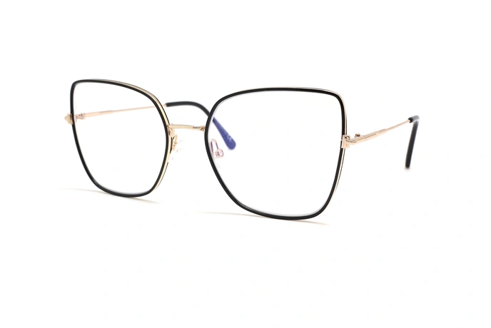 عینک طبی زنانه تام فورد فریم فلزی خاص مربعی گربه ای بزرگ ترکیب رنگ طلایی و مشکی - عکس از زاویه سه رخ